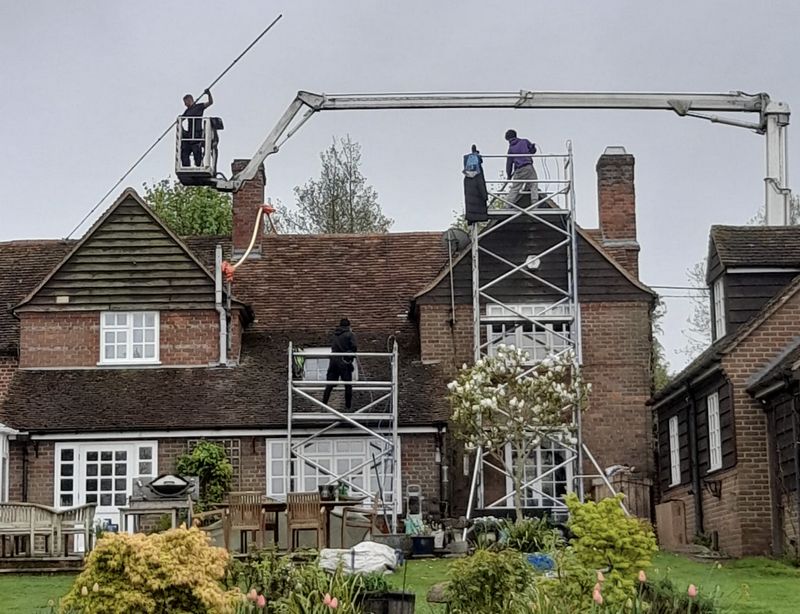 The Roof Moss Cleaners using cherry picker and scaffolding to clean roof safely and professionally in London Colney, Hertfordshire